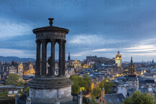 Edinburgh, Scotland, UK. The Dugald Stewart Monument on Calton Hill overlooking the old town in the evening light. UNESCO