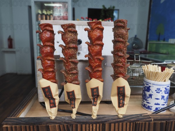 Various spiced meat skewers are presented at a street food market, Zhujiajiao Ancient Town, Shanghai, China