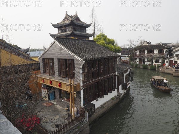 A Chinese-style building on the banks of a canal on a traditional boat, Zhujiajiao Ancient Town, Shanghai, China