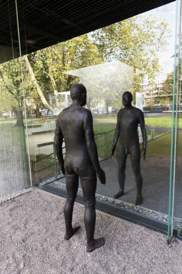 Male figure looking at her real reflection, Reflections II sculpture by sculptor Antony Gormley, Lehmbruck Museum, Duisburg, North Rhine-Westphalia, Germany