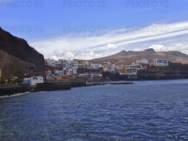 Coastal town with buildings along the sea line under a blue sky, Sardina del Norte, Gran Canaria, Canary Islands, Spain