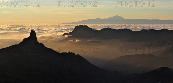 Atmospheric mountain scenery at sunset over a sea of clouds, Roque Nublo, Gran Canaria, Canary Islands, Spain