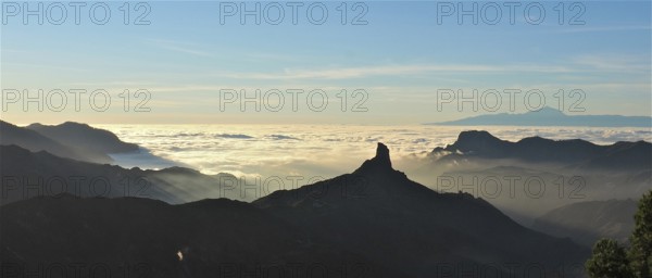 Unique mountain silhouette at sunset over a sea of clouds, Roque Nublo, Gran Canaria, Canary Islands, Canary Islands, Spain