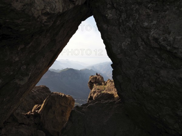 View through a rocky frame of a distant mountain landscape, Roque Nublo, Gran Canaria, Canary Islands, Canary Islands, Spain
