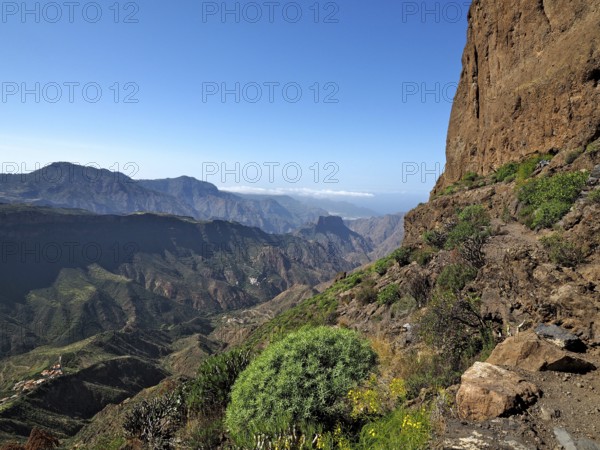 View of a deep valley and distant mountains from a mountain trail, Roque Bentayga, Gran Canaria, Canary Islands, Canary Islands, Spain