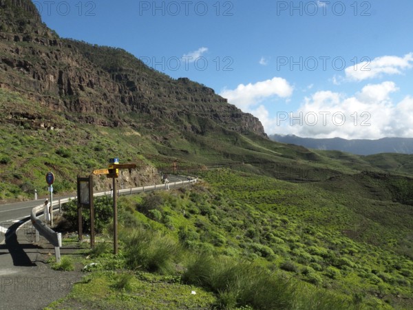 Scenic road through green mountains with clear skies, GC 200 near La Aldea de San Nicolas, Gran Canaria, Canary Islands, Spain