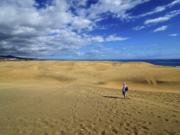 Wide sand dune landscape with a hiker under the blue sky, dunes of Maspalomas, Gran Canaria, Canary Islands, Canary Islands, Spain