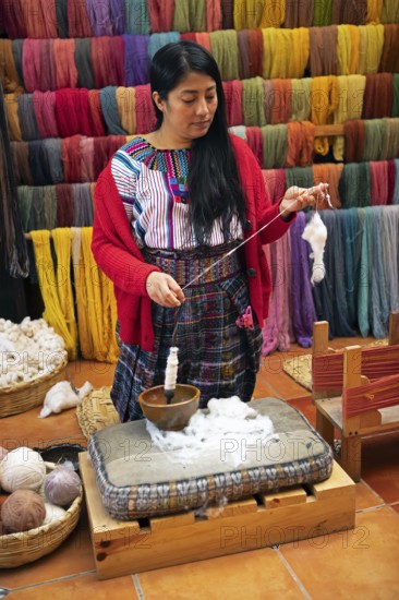 Maya woman, 42 years old, spinning cotton, traditional craft in a woman's cooperative, San Juan la Laguna, Atitlán, Sololá Department, Guatemala