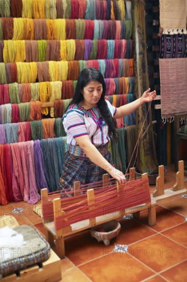 Maya woman, 42 years old, places cotton in a weaving frame, traditional craft in a woman's cooperative, San Juan la Laguna, Atitlán, Sololá Department, Guatemala