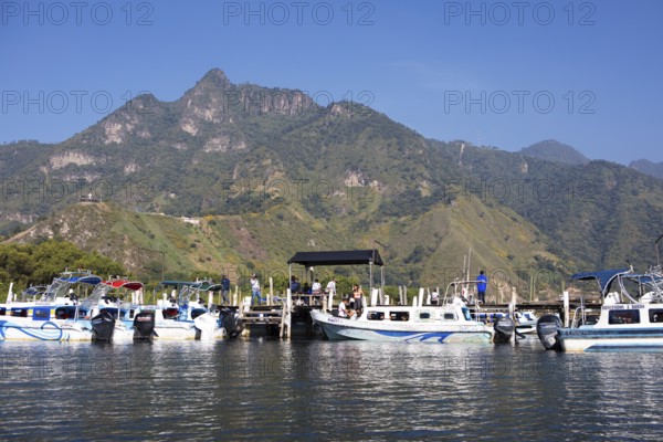 Colourful boats in the port of San Juan la Laguna, the mountains behind, Atitlán, Sololá Department, Guatemala