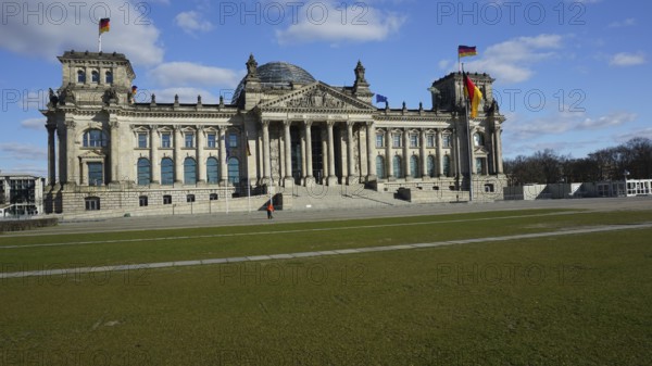 Historic building, Reichstag, Bundestag with dome and German flags on a sunny day, without people, during corona, Berlin