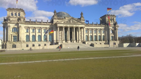 The Reichstag building in Berlin under a clear, blue sky, deserted, without people during corona, Berlin