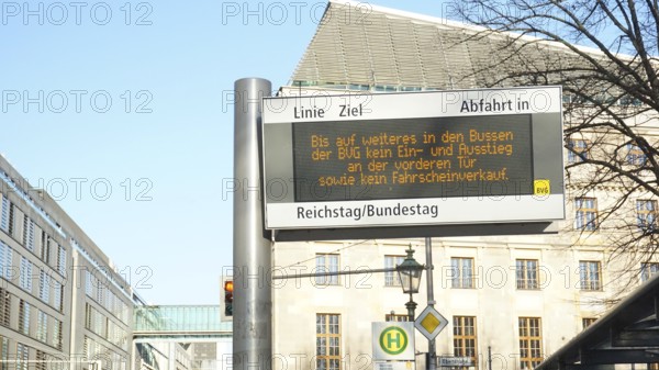 Bus stop with digital information sign in the city, sign during corona, Berlin