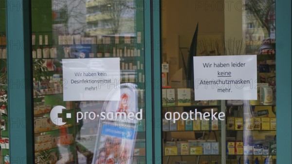 Pharmacy entrance with signs about missing disinfectants and protective masks, during corona, Berlin