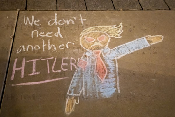 Phoenix, Arizona - Messages written in chalk on the sidewalk at the Arizona State Capitol during a protest against ICE and immigrant deportations. The messages were washed away the following morning, only steps away from a monument honoring the Bill of Rights' first amendment