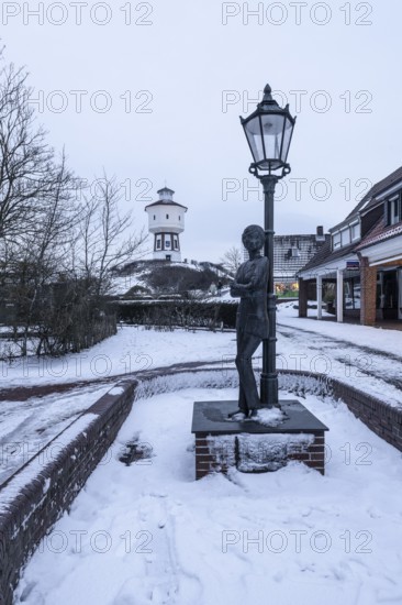 Water tower and Lale Andersen sculpture in snow, Langeoog, Lower Saxony, Germany