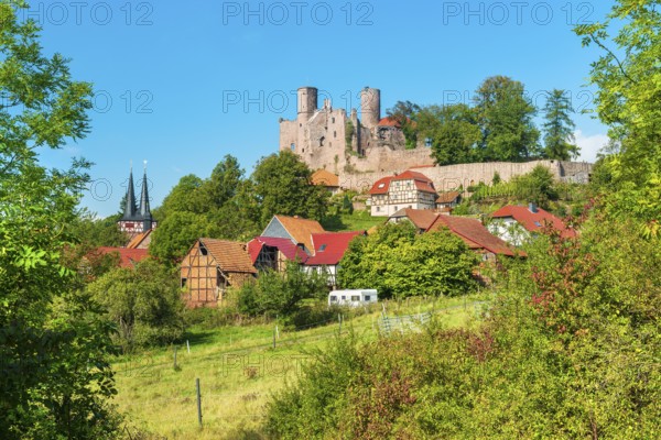 View of the ruins of Hanstein Castle and the small village of Rimbach, half-timbered houses and village church with half-timbered towers, Bornhagen, Eichsfeld, Thuringia, Germany