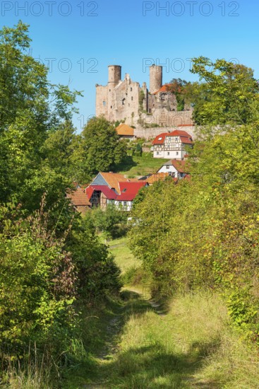 View of the ruins of Hanstein Castle and the small village of Rimbach with half-timbered houses, Bornhagen, Eichsfeld, Thuringia, Germany