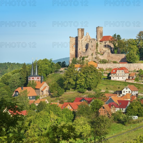 View of the ruins of Hanstein Castle and the small village of Rimbach, half-timbered village church with half-timbered towers, Bornhagen, Eichsfeld, Thuringia, Germany