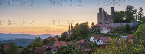 View of the ruins of Hanstein Castle and the small village of Rimbach with village church with half-timbered towers at sunset, Bornhagen, Eichsfeld, Thuringia, Germany