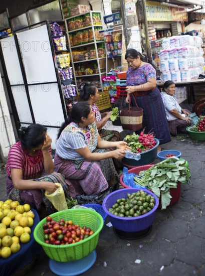 Mayan woman wearing traditional clothes selling vegetables in Santiago de Atitlán, Sololá Department, Guatemala