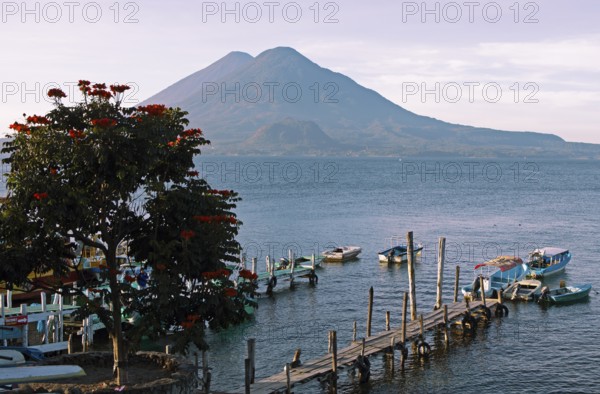 Boats on the dock, Lake Atitlán or Lake Atitlán in the morning, the volcanoes Atitlán and Toliman in the back, Panajachel, Sololá Department, Guatemala