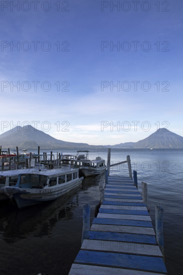 Boats on the pier, Lake Atitlán or Lake Atitlán in the morning, the volcanoes San Pedro, Atitlán and Toliman in the back, Panajachel, Sololá Department, Guatemala