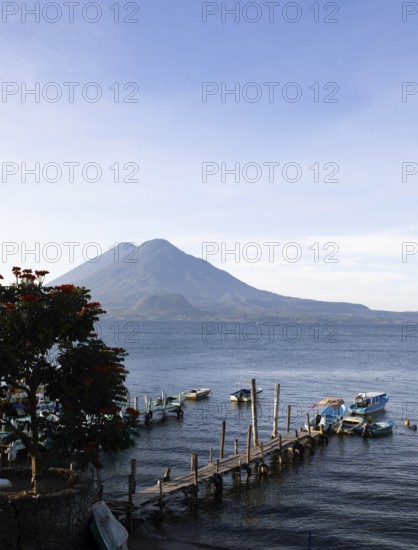 Boats on the dock, Lake Atitlán or Lake Atitlán in the morning, the volcanoes Atitlán and Toliman in the back, Panajachel, Sololá Department, Guatemala
