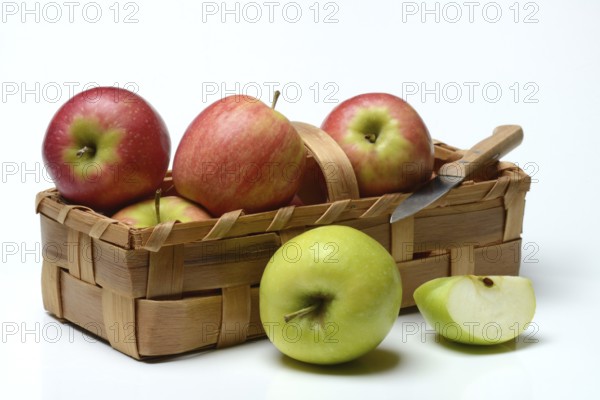 Several apples in chip basket, varieties 'Pink Lady' and 'Greenstar'