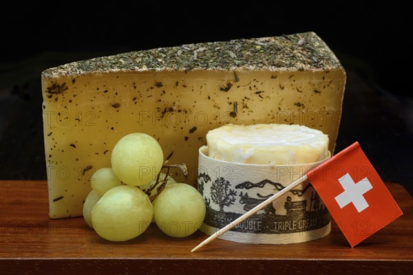 Plate of Swiss cheese, Gstaad mountain cheese with herbs and cream cheese 'Fette Berta', Switzerland