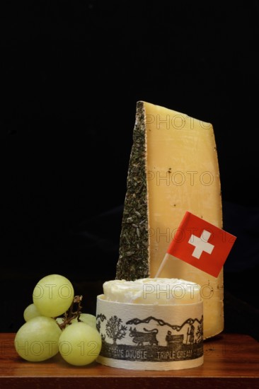 Plate of Swiss cheese, Gstaad mountain cheese with herbs and cream cheese 'Fette Berta', Switzerland