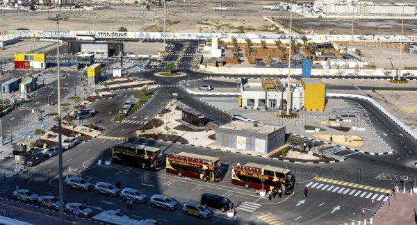 Taxi and hop on hop off buses are waiting for tourists in the cruise terminal parking lot, Abu Dhabi, UAE, United Arab Emirates