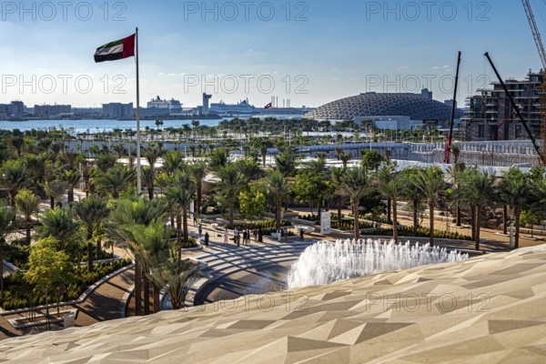 View of Al Masar Garden and the roof of Louvre Abu Dhabi from the Zayed National Museum platform, the museum with the park and adjacent construction sites is the heart of the cultural district on Saadiyat Island, Abu Dhabi, United Arab Emirates