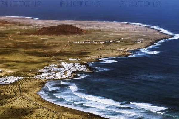 Coastal village of Caleta de Famara on a winding coast with waves and sweeping skies, Mirador de Ermita de Las Nieves, Lanzarote