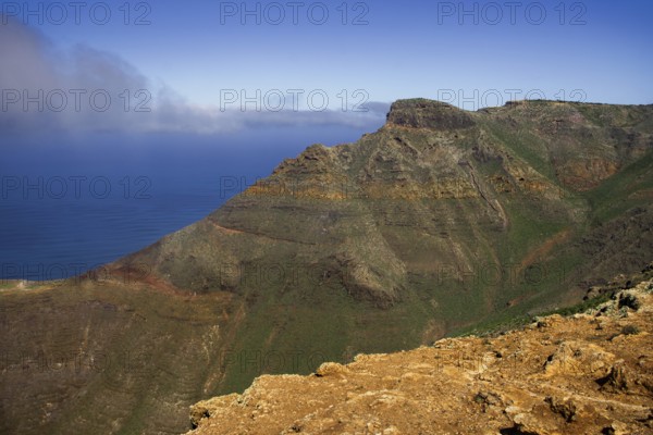 Magnificent view from the Mirador de Ermita de Las Nieves of the sea and the mountain wall of the Famara massif and blue sky, partly cloudy, Mirador de Ermita de Las Nieves, Lanzarote