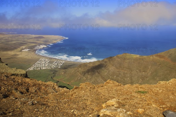 Magnificent view from the Mirador de Ermita de Las Nieves of the coastal village of Caleta de Famara and the sea with blue sky, Mirador de Ermita de Las Nieves, Lanzarote