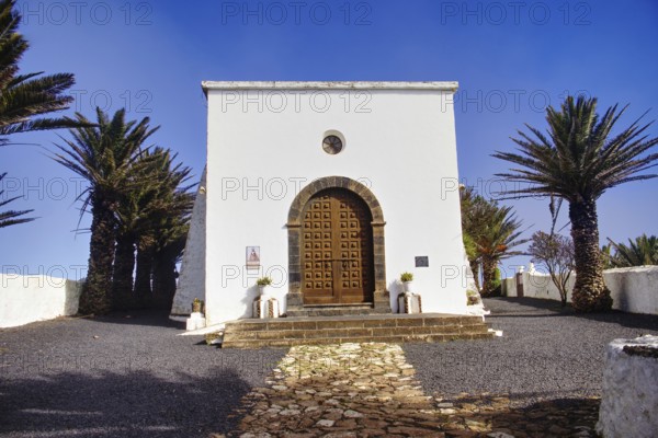 Small church (Ermita de Las Nieves) with palm trees in front of a clear sky, Mirador de Ermita de Las Nieves, Lanzarote