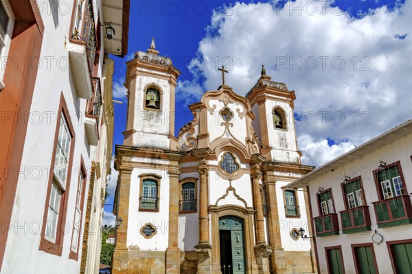 Baroque cathedral facade surrounded by old houses in the historic city of Ouro Preto, Ouro Preto, Minas Gerais, Brazil