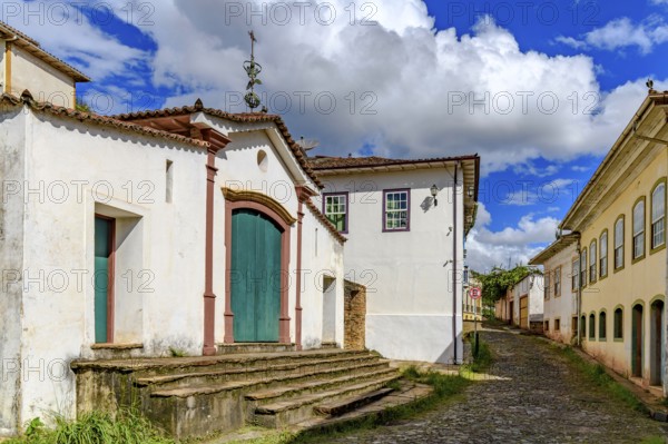 Historic chapel on a cobblestone street and old colonial houses in Ouro Preto, Ouro Preto, Minas Gerais, Brazil