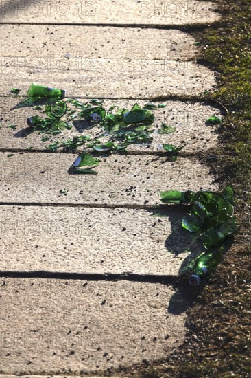 Broken glass on a sidewalk, danger to passers-by, cyclists and animals, Germany
