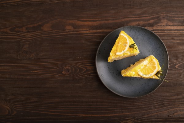 Lemon cake on brown wooden background, top view, flat lay, copy space