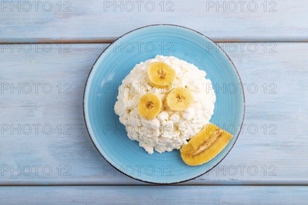 White ?ottage cheese, Curd, with Banana on blue wooden background, top view, flat lay, close up