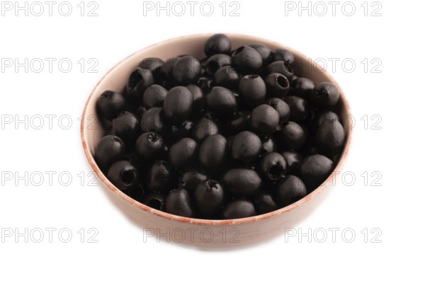 Fresh black olives in ceramic bowl Isolated on white background. side view, close up