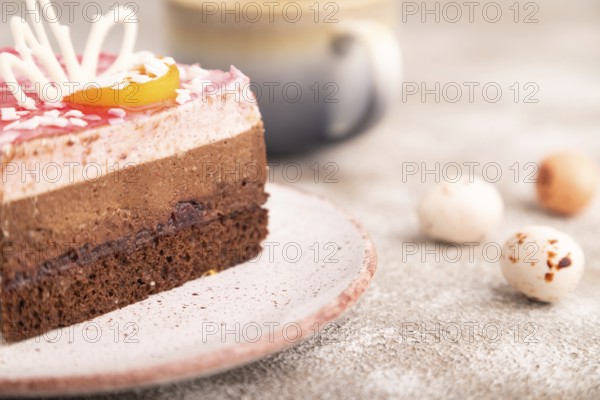 Chocolate cake on brown concrete background, cup of coffee, side view, close up, selective focus