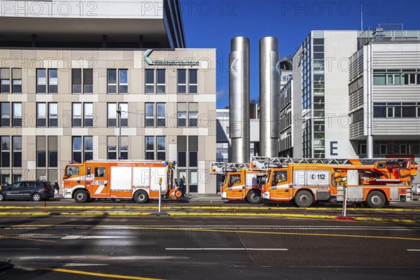 Fire service at Stuttgart Hospital. Fire trucks are parked in front of the building following a false alarm. Stuttgart, Baden-Württemberg, Germany