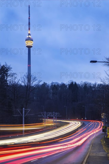 The television tower is the landmark of the state capital Stuttgart. The pulpit is illuminated in the evening. Before that, there are traces of light from vehicles. The SWR TV Tower is celebrating its 70th anniversary in 2026. Stuttgart, Baden-Württemberg, Germany