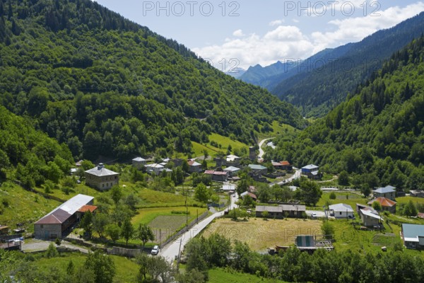 Village nestled in a green valley with mountains in the background, Bogreshi, road 7, Mingrelia and Upper Svaneti region, High Caucasus, Georgia