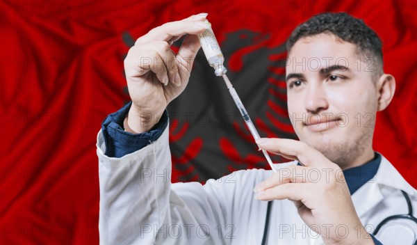Doctor holding syringe on Albania flag background. Medical professional holding syringe with Albanian flag in the background