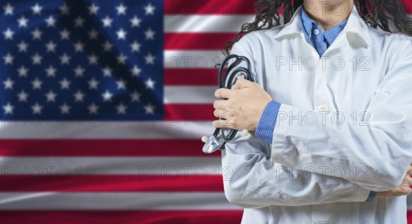 Healthcare professional with United States flag background. Professional doctor holding stethoscope on United States flag background