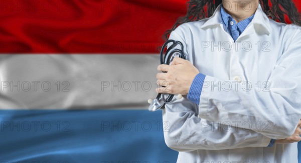 Healthcare professional with Luxembourg flag background. Professional doctor holding stethoscope on Luxembourg flag background